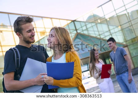 Happy student having conversation next modern college. Education concept