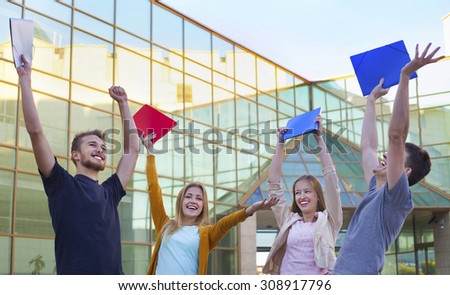Group of cheerful student show education success raising hands up with folders