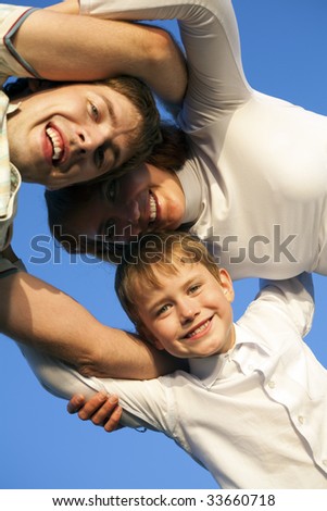 Below view of happy family members looking at camera with smiles