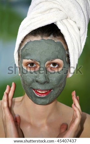 Woman with clay mask looking at camera