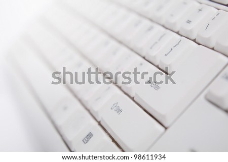 Close-up of white keyboard with enter key in focus