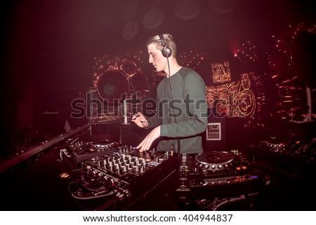 DJ mixing live in a club with led panel decor