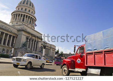 HAVANA-SEP 7: Old cars running and parked in front of the Capitol on Sep 7, 2011 in Havana. Before a new law issued on October 2011, cubans could only trade cars that were on the road before 1959.