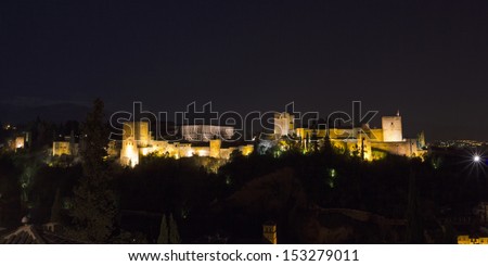 The complex of the Alhambra, the Nasrid palaces, the Palace of Charles V and the Torre de la Vela, at night. Granada, Spain