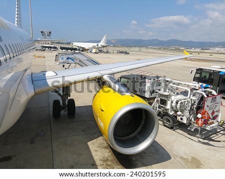 BARCELONA- AUGUST 5: Airbus A320 of the Vueling Airlines receiving fuel from tanker truck at Barcelona International Airport on August 5, 2014 in Barcelona, Catalonia, Spain.