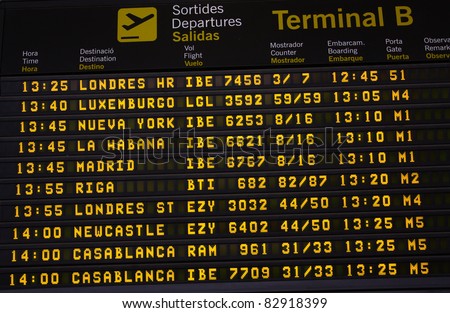 An electronic airport airplane departures board with times and destinations.