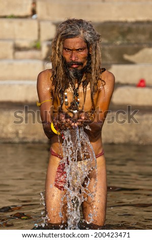 VARANASI INDIA MAR 3 2013 Man praying in waters of Ganges river during Kumbh Mela festival Varanasi India VARANASI INDIA MAR 3 2013 Man praying in waters of Ganges river during Kumbh Mela festival Varanasi India