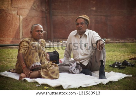 AGRA, INDIA - NOVEMBER 18:  Indian Wife and Husband resting near Agra Fort, during holy festival , Nov. 18, 2012.  Agra is the ancient city, attracting Indians from all over the subcontinent.