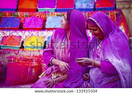 JAIPUR, INDIA - MARCH 17:Lady in violet, covered in paint on Holi festival, March 17, 2013, Jaipur, India. Holi, the festival of colors, the arrival of spring,  one of the biggest festivals in India