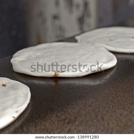 Indian Parrotha bread cooking on hotplate in marketplace
