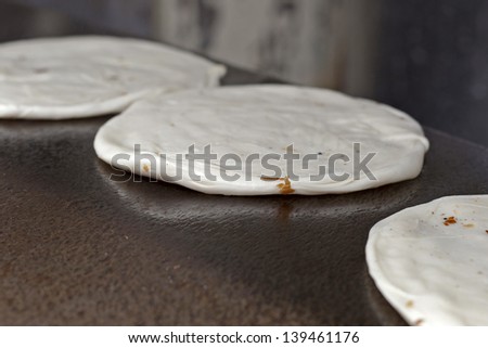 Indian Parrotha bread cooking on hotplate in marketplace