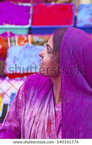 JAIPUR, INDIA - MARCH 17: Lady in violet,  in paint on Holi festival, March 17, 2013, Jaipur, India. Holi, the festival of colors, marks the arrival of spring, one of the biggest festivals in India