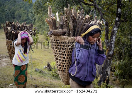 ANNAPURNA AREA, NEPAL - NOVEMBER 13: Several Tibetan women in national clothes with basket on the road on November 13, 2012 in Annapurna District, Nepal.