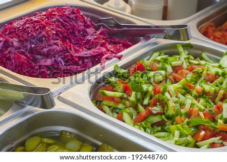 Assortment of fresh vegetable salads and colorful spicy pickles on the traditional food stand selling shawarma sandwiches and other grilled meats in the Old City of Jerusalem (Israel).