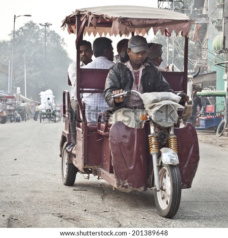 DELHI, INDIA - NOVEMBER 10: Morning on a street at November 10, 2013 in Old Delhi, India. Indian capital still uses man powered rickshaws as a usual mean of transport.