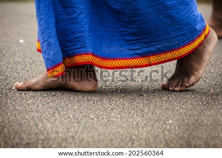 Feet of indian man in traditional clothes