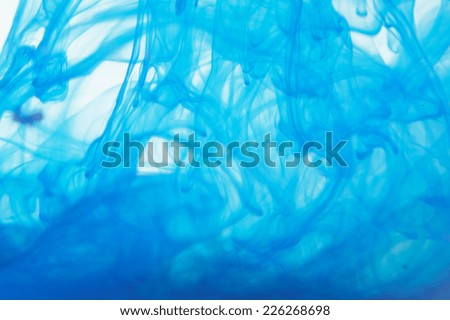 Blue liquid in water making abstract forms