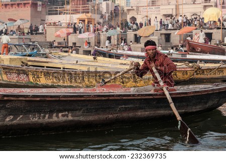 Varanasi, India - November 15, 2013: Man sailing on the boat on Ganges river during Kumbh Mela festival  on November 15, 2013
