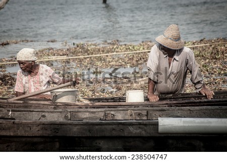 FORT KOCHI, INDIA - DECEMBER 20: fishermen fishing in their wooden boats in the early morning on December 20, 2012 in Fort Kochi, Kerala, India.