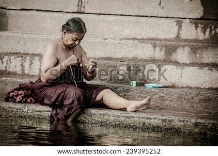 VARANASI - NOVEMBER 22: Unidentified hindu women on the sacred Ganges river banks at Dashashwamedh ghat on November 22, 2012 in Varanasi, State of Uttar Pradesh, India