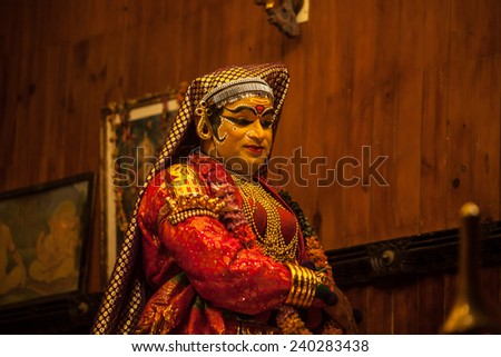 FORT COCHIN -  DECEMBER 7: Unidentified Kathakali performer applying face make-up prior to a performance on December 7, 2012 in South India. Kathakali is the ancient classical dance form of Kerala.
