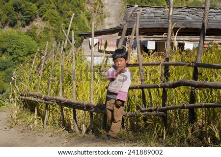 GORKHA, NEPAL - NOVEMBER 12: Portrait of small gorkhas childr near the house  near field on november 12, 2013 in Gorkha District, Nepal