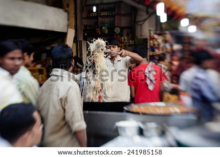NEW DELHI - NOVEMBER 6: Man cooking and selling India\'s popular street food  on November 6, 2013 in New Delhi, India.