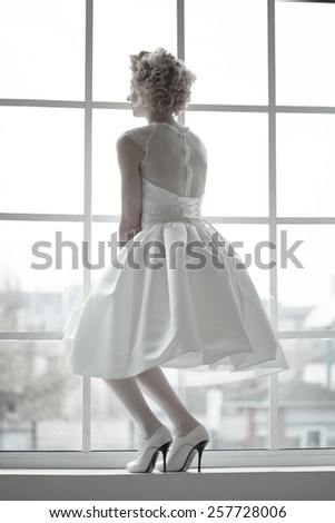 The bride standing on the window