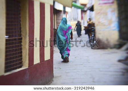 VARANASI - NOVEMBER 22: Unidentified hindu woman on the streets of sacred Varanasi old town on November 22, 2012 in Varanasi, State of Uttar Pradesh, India
