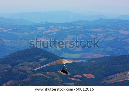 Hang glider pilot in Italian mountains