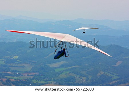 MONTE CUCCO, ITALY - AUGUST 12: Competitor of the Dutch Open-2010 hang gliding competitions takes part on the Monte Cucco mountain on August 12, 2010 near Cigillo, Italy.