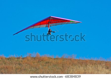 CRIMEA, UKRAINE - SEPTEMBER 9: Competitor  of the Grininko hang gliding competitions takes part in the Klementieva mountain on September 9, 2010 in Crimea, Ukraine