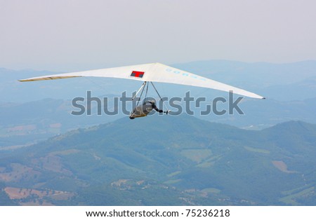 MONTE CUCCO, ITALY - AUGUST 12: Competitor  of the Dutch Open-2010 hang gliding competitions takes part on the Monte Cucco mountain on August 12, 2010 near Cigillo, Italy.