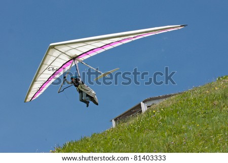 FIESH, SWITZERLAND - JULY 8: Competitor of the Fiesh Open hang gliding competitions takes part on July 8, 2011 in Fiesh, Switzerland