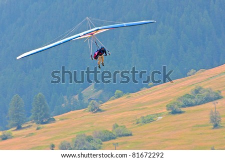 FIESH, SWITZERLAND - JULY 8: Competitor of the Fiesh Open hang gliding competitions takes part on July 8, 2011 in Fiesh, Switzerland