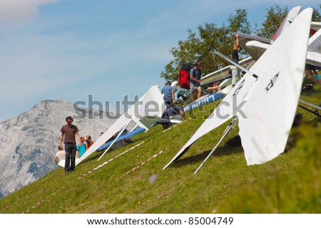 TOLMIN, SLOVENIA - AUGUST 20: Hang gliders standing on start in  the Kobala Open-2011 hang gliding competitions on August 20, 2011 near Tolmin, Slovenia.