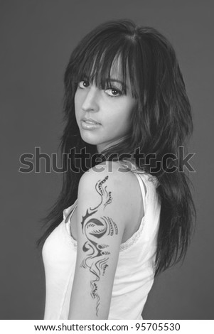 Beauriful model in white clothes with tattoo on her arm