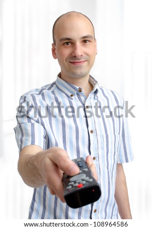 young man with a TV remote