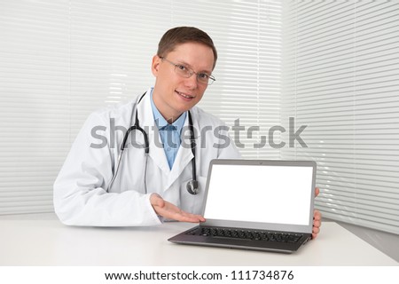 young doctor in lab coat with laptop