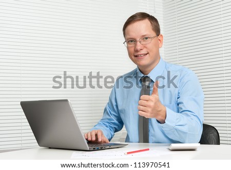 business man showing thumbs up at office