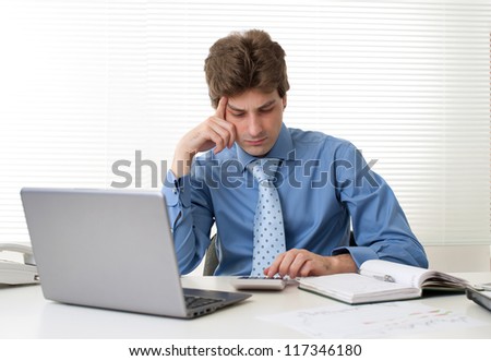 Busy businessman with laptop computer