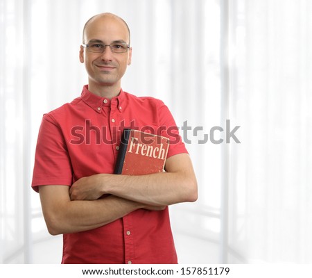friendly student man with French book. Education concept