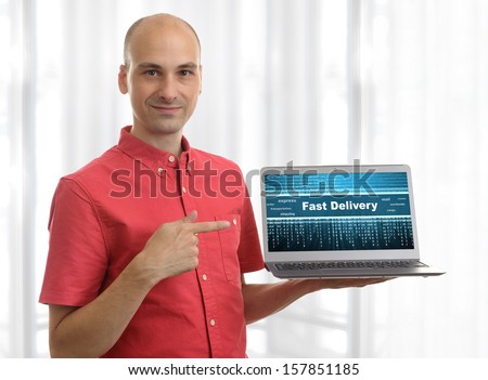 Man pointing on fast delivery logo on his Laptop