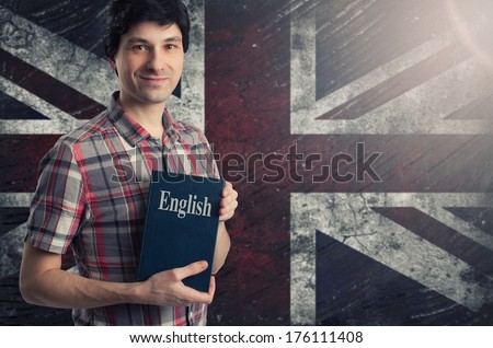 Man with a book over Grungy UK Flag Background