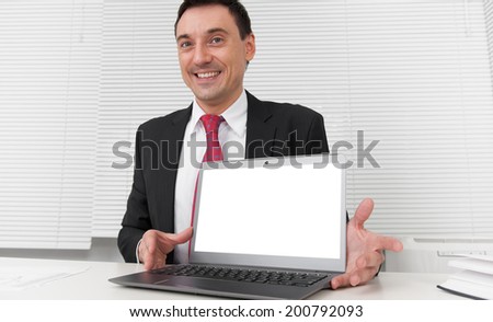 advertisement, business and technology concept. Smiling businessman with blank laptop screen