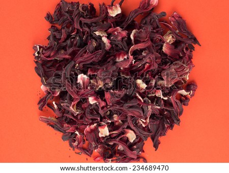 close up of dry hibiscus flowers over red background