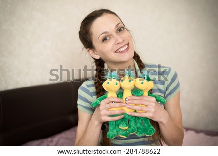 cute young woman with Stuffed Toys at home
