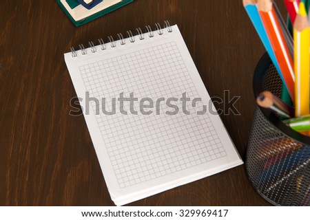Blank Note Pad with copy space and colorful Pencils