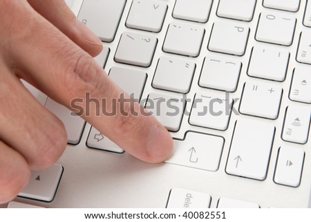 male finger pressing computer key