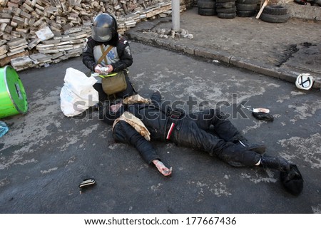 KIEV, UKRAINE - FEBRUARY 18, 2014: Military doctor provides medical care to the injured person. Kiev, Ukraine, Kiev, 18.02.2014
